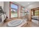Luxurious bathroom with soaking tub, walk-in shower, and natural light at 1122 Forest Trails Dr, Castle Pines, CO 80108