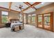 Bedroom with beamed ceiling, natural light, and ensuite bathroom at 1122 Forest Trails Dr, Castle Pines, CO 80108