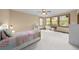 Cozy bedroom with natural light that pours in from three large windows and highlights the spacious room at 1122 Forest Trails Dr, Castle Pines, CO 80108