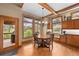 Eat-in kitchen with hardwood floors, wood cabinets, and an abundance of natural light at 1122 Forest Trails Dr, Castle Pines, CO 80108