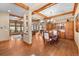 Open concept dining room boasts hardwood floors, wood beam ceiling and custom-built cabinetry at 1122 Forest Trails Dr, Castle Pines, CO 80108