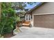 Charming home with a two-car garage, a wooden deck, and a beautifully landscaped front yard at 1122 Forest Trails Dr, Castle Pines, CO 80108