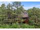 Two-story home surrounded by lush greenery, featuring a private deck and a blend of natural beauty at 1122 Forest Trails Dr, Castle Pines, CO 80108