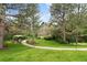 Charming exterior view of a two-story home surrounded by mature trees and lush landscaping creating a private oasis at 1122 Forest Trails Dr, Castle Pines, CO 80108