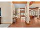 A grand foyer with wood floors, decorative columns, and a view into the living spaces at 1122 Forest Trails Dr, Castle Pines, CO 80108
