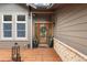 Inviting front entrance featuring a wood door, decorative wreath, and a charming wooden porch with stone accents at 1122 Forest Trails Dr, Castle Pines, CO 80108