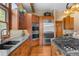 Eat-in kitchen features wood cabinets, granite countertops, stainless appliances and hardwood floors at 1122 Forest Trails Dr, Castle Pines, CO 80108