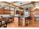 Spacious kitchen features wood cabinets, granite countertops, stainless appliances and hardwood floors at 1122 Forest Trails Dr, Castle Pines, CO 80108