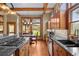 Eat-in kitchen with hardwood floors, wood cabinets, granite countertops, stainless appliances, and natural light at 1122 Forest Trails Dr, Castle Pines, CO 80108