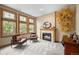 Cozy living room features natural light, a fireplace, and comfortable seating at 1122 Forest Trails Dr, Castle Pines, CO 80108