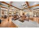 Spacious living room featuring wood floors, exposed beam ceilings, and open access to the kitchen at 1122 Forest Trails Dr, Castle Pines, CO 80108