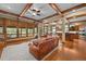 The open-concept living room features hardwood floors, decorative beams, and large windows for plenty of light at 1122 Forest Trails Dr, Castle Pines, CO 80108