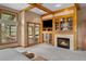 Inviting living room with cozy fireplace, custom built-ins, and access to the deck at 1122 Forest Trails Dr, Castle Pines, CO 80108
