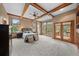 Bright main bedroom with hardwood floors, ceiling beams, and access to a private balcony at 1122 Forest Trails Dr, Castle Pines, CO 80108