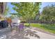 Charming backyard featuring outdoor seating, lush lawn, mature tree and storage shed at 6857 S Franklin Cir, Centennial, CO 80122