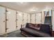 Finished basement features a futon, multiple storage closets, and access to stairs at 6857 S Franklin Cir, Centennial, CO 80122