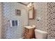Charming half bathroom featuring vintage floral wallpaper, small wooden sink and a toilet at 6857 S Franklin Cir, Centennial, CO 80122