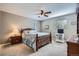 Comfortable bedroom with a wooden bed frame, matching nightstand, and soft carpet at 6857 S Franklin Cir, Centennial, CO 80122
