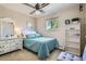 Bright bedroom featuring a ceiling fan, plush carpet, and ample natural light from the window at 6857 S Franklin Cir, Centennial, CO 80122