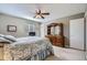 Cozy bedroom featuring a wooden bed frame, dresser with mirror, ceiling fan and neutral-toned walls at 6857 S Franklin Cir, Centennial, CO 80122