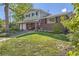 Charming two-story home featuring a well-maintained lawn and inviting front porch with seating at 6857 S Franklin Cir, Centennial, CO 80122