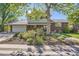 Charming home with brick and siding, a well-manicured lawn, and an attached two car garage at 6857 S Franklin Cir, Centennial, CO 80122