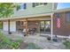 Inviting covered front porch with seating, brick accents, and a stone pathway to the front door at 6857 S Franklin Cir, Centennial, CO 80122
