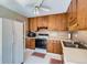 Functional kitchen with wood cabinets, classic appliances, and ample counter space for cooking at 6857 S Franklin Cir, Centennial, CO 80122