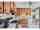 Functional kitchen with wood cabinets, classic appliances, and ample counter space at 6857 S Franklin Cir, Centennial, CO 80122