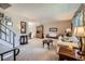 Bright living room with neutral tones, plush carpeting, and easy access to the dining area at 6857 S Franklin Cir, Centennial, CO 80122