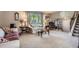 Cozy living room with neutral colors, plush carpeting, and abundant natural light from a large window at 6857 S Franklin Cir, Centennial, CO 80122