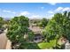 A tranquil home with a beautiful yard is surrounded by mature trees, showcasing a serene outdoor living space at 7486 S Washington St, Centennial, CO 80122
