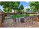 Backyard featuring a fire pit, raised garden beds, and a fenced perimeter for privacy and outdoor entertainment at 7486 S Washington St, Centennial, CO 80122