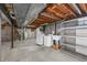 The unfinished basement features laundry hookups and exposed ceilings and beams at 7486 S Washington St, Centennial, CO 80122