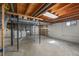 The unfinished basement features laundry hookups and exposed ceilings and beams at 7486 S Washington St, Centennial, CO 80122