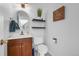 Charming half-bathroom features floating shelves, modern fixtures, and a stylish design at 7486 S Washington St, Centennial, CO 80122