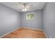 This cozy bedroom is light and bright, has gleaming hardwood floors, and a ceiling fan at 7486 S Washington St, Centennial, CO 80122