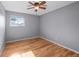 This cozy bedroom is light and bright, has gleaming hardwood floors, and a ceiling fan at 7486 S Washington St, Centennial, CO 80122