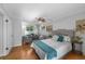 Spacious bedroom with a sitting area, ceiling fan, and bright windows at 7486 S Washington St, Centennial, CO 80122
