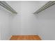 This is a bright, empty closet with hardwood floors and metal shelving at 7486 S Washington St, Centennial, CO 80122