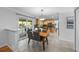 Open-concept kitchen and dining area with sliding glass doors to a covered patio and modern stainless appliances and accents at 7486 S Washington St, Centennial, CO 80122