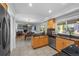 Well-lit kitchen with wooden cabinets, granite countertops, stainless steel appliances, and an open view into the dining area at 7486 S Washington St, Centennial, CO 80122