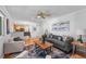 Bright living room features hardwood floors, a ceiling fan, and flows into the kitchen and dining areas at 7486 S Washington St, Centennial, CO 80122