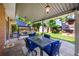 Covered patio with stylish dining set, comfortable swing, and garden views for relaxed outdoor living at 7486 S Washington St, Centennial, CO 80122