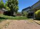 Large backyard features a mixture of green grass and gravel area and mature trees at 1251 N Burlington Dr, Castle Rock, CO 80104