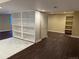Finished basement with hardwood floors, built-in shelving and a door at 1251 N Burlington Dr, Castle Rock, CO 80104