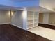 Finished basement with hardwood floors, painted stairs, and built-in shelving at 1251 N Burlington Dr, Castle Rock, CO 80104
