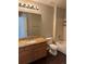 Bathroom with wood vanity, granite countertop, mirror, and shower at 1251 N Burlington Dr, Castle Rock, CO 80104