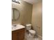 Bathroom with a round mirror, toilet, and sink at 1251 N Burlington Dr, Castle Rock, CO 80104