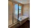 Bathroom featuring tub with glass doors and a bright window at 1251 N Burlington Dr, Castle Rock, CO 80104